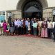 A group photo showing participants of the review meeting for the MERIT project in front of the Main Building. College of Agricultural and Environmental Sciences (CAES) comprehensive impact review of the Environmental Risk Management Under Increasing extremes and Uncertainty (MERIT) Project, bringing together faculty, researchers, students, and partners from Ugandan and Norwegian institutions, 17th November 2025, Main Building, Makerere University, Kampala Uganda, East Africa.