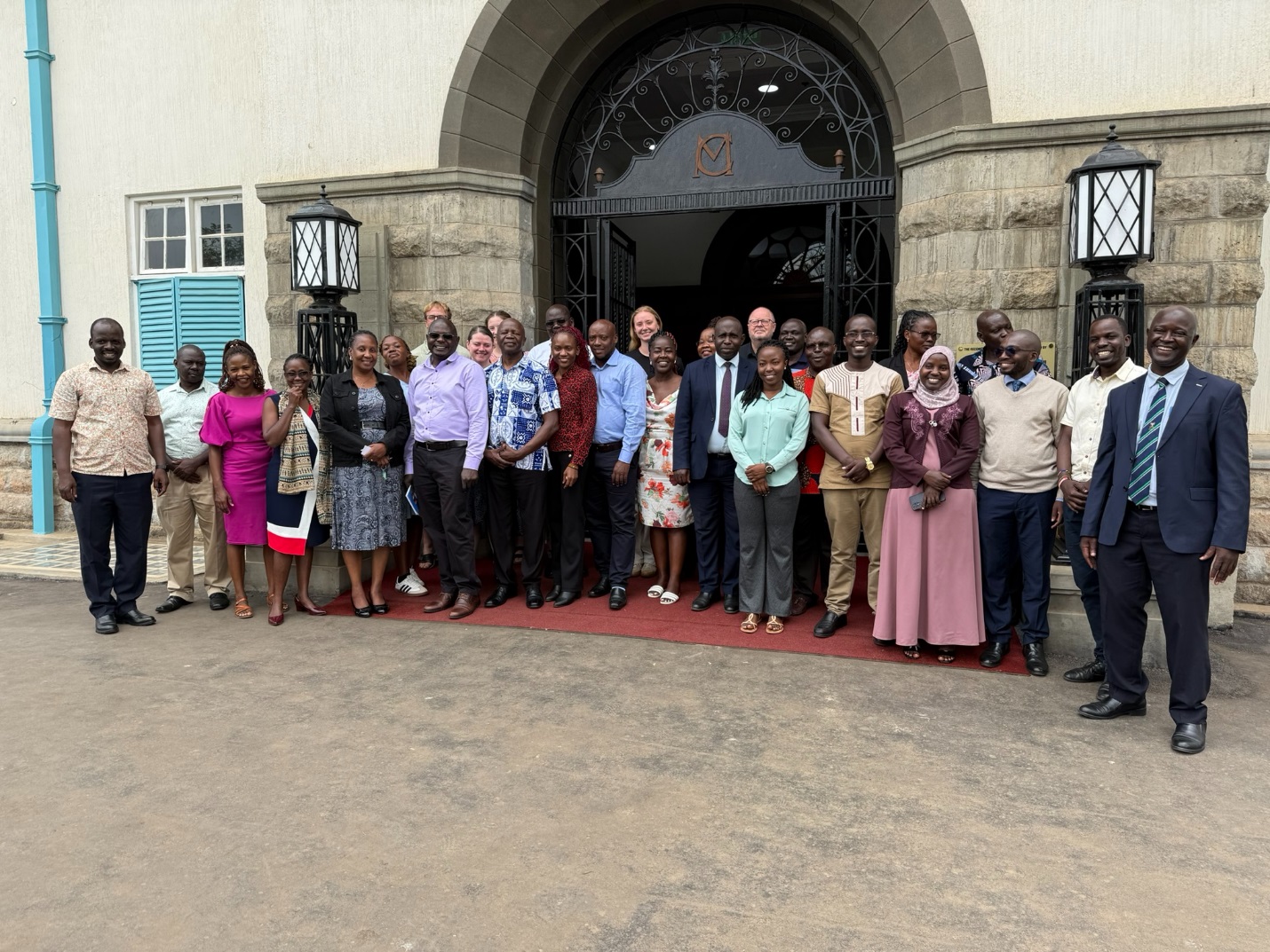 A group photo showing participants of the review meeting for the MERIT project in front of the Main Building. College of Agricultural and Environmental Sciences (CAES) comprehensive impact review of the Environmental Risk Management Under Increasing extremes and Uncertainty (MERIT) Project, bringing together faculty, researchers, students, and partners from Ugandan and Norwegian institutions, 17th November 2025, Main Building, Makerere University, Kampala Uganda, East Africa.