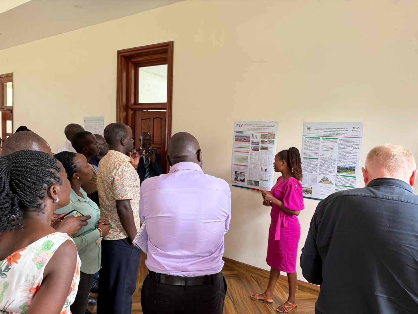 A photo of one of the student beneficiaries of the MERIT project making a presentation of her research findings. College of Agricultural and Environmental Sciences (CAES) comprehensive impact review of the Environmental Risk Management Under Increasing extremes and Uncertainty (MERIT) Project, bringing together faculty, researchers, students, and partners from Ugandan and Norwegian institutions, 17th November 2025, Main Building, Makerere University, Kampala Uganda, East Africa.