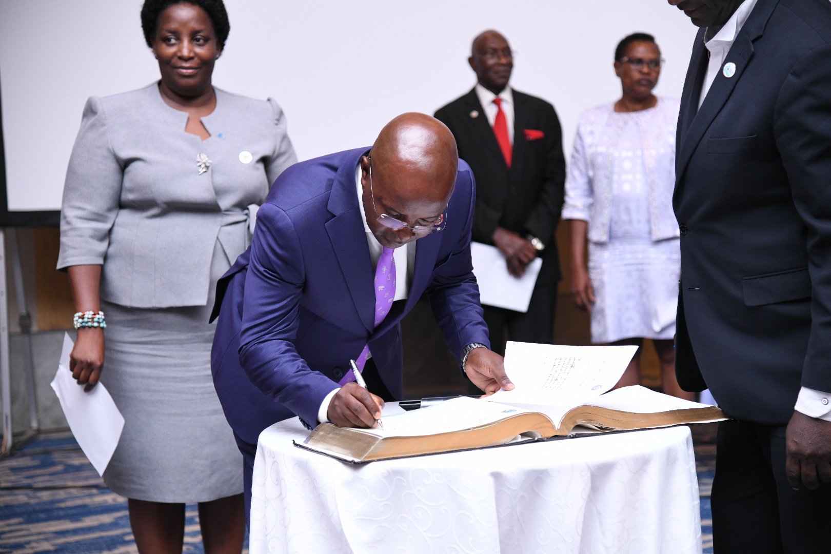 Prof. Bbaale signs the UNAS book of records. Professor Edward Bbaale, Principal of the College of Business and Management Sciences (CoBAMS), Makerere University, inducted into the prestigious fellowship of the Uganda National Academy of Sciences (UNAS), 31st October 2025, Kampala Uganda, East Africa.