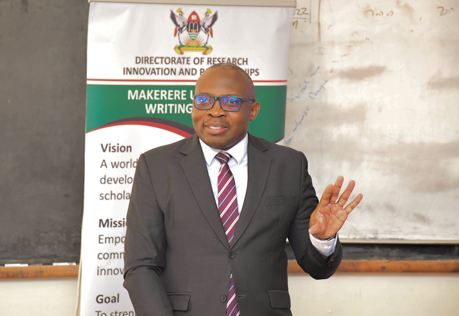 Prof. Ronald Bisaso, Deputy Principal-CEES and MakWC team member emphasizing the need for standardized templates. Makerere University Writing Centre (MakWC), Directorate of Research, Innovations and Partnerships (DRIP), workshop aimed at enhancing professional writing skills among University staff, second training, 13th November 2025, School of Business Conference Hall, College of Business and Management Sciences (CoBAMS), Kampala Uganda, East Africa.