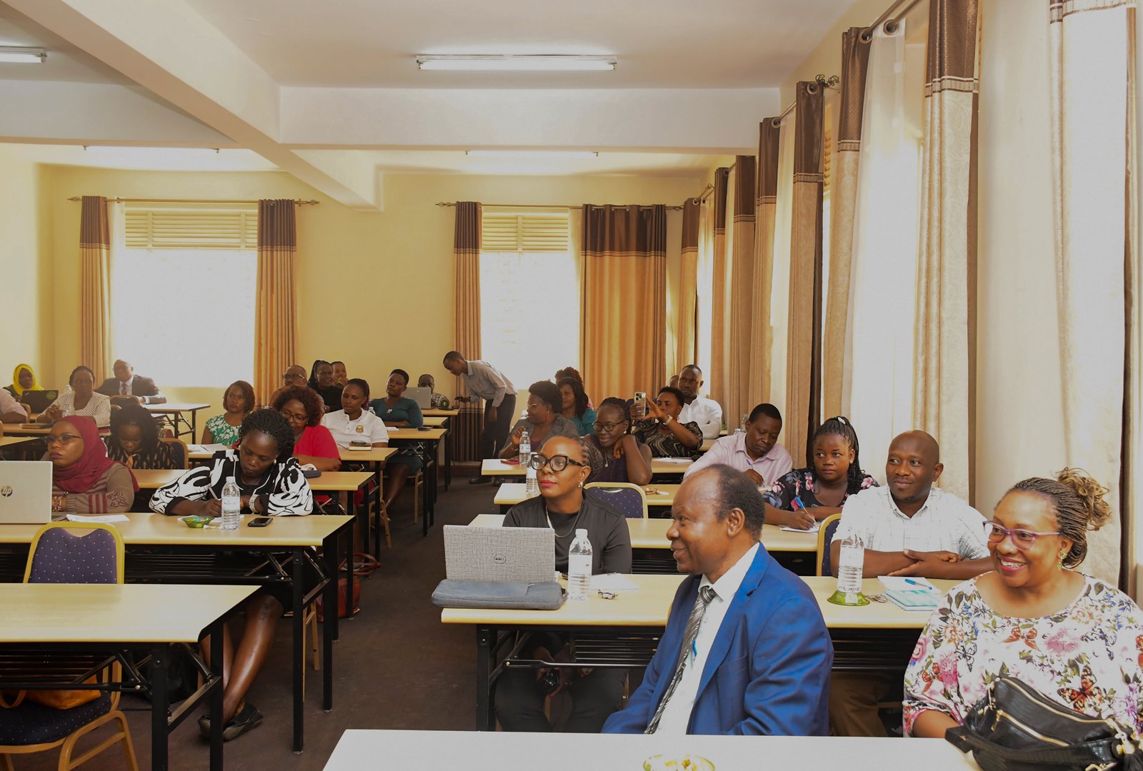 Workshop participants listening to a captivating presentation. Makerere University Writing Centre (MakWC), Directorate of Research, Innovations and Partnerships (DRIP), workshop aimed at enhancing professional writing skills among University staff, second training, 13th November 2025, School of Business Conference Hall, College of Business and Management Sciences (CoBAMS), Kampala Uganda, East Africa.