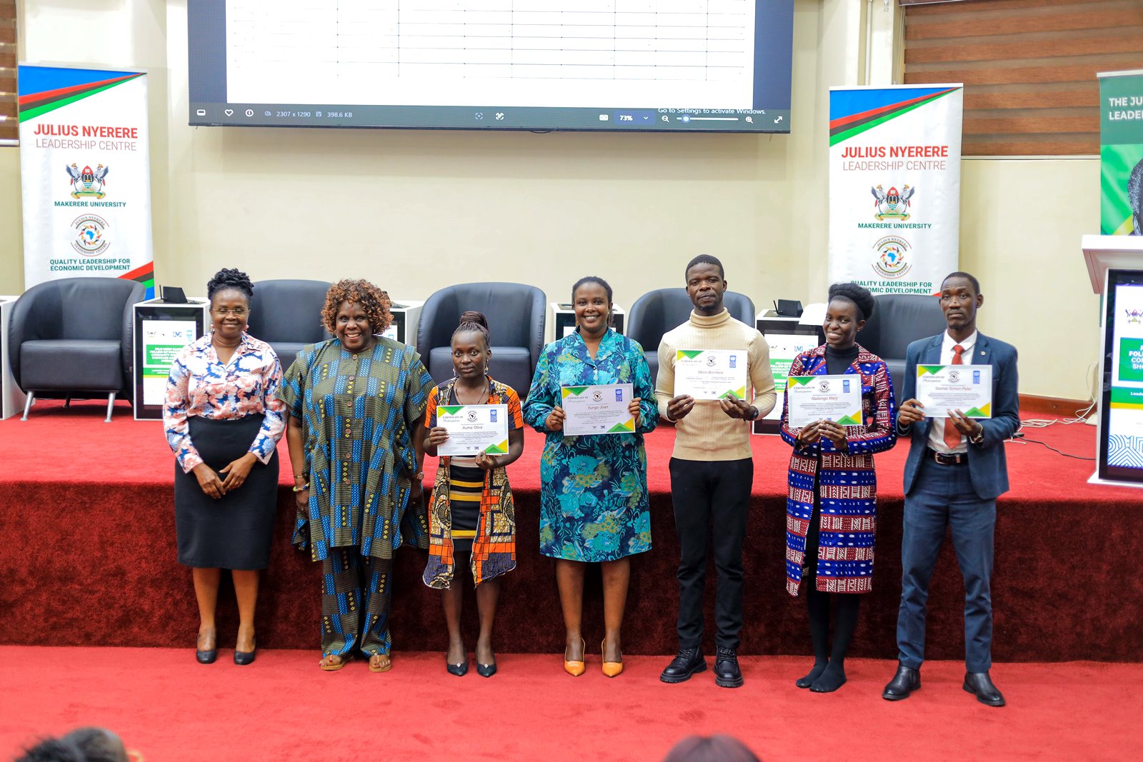 The five JNLC-UNDP Alumni Community Innovation Winners pose for a group photo with Dr. Nansozi K. Muwanga-Executive Director of JNLC and Ms. Annet Mpabulungi Wakabi-Team Leader, Governance and Peace, UNDP. Julius Nyerere Leadership Centre (JNLC) at Makerere University, in partnership with the United Nations Development Programme (UNDP), two-day Community Innovation Showcase and Alumni Workshop 18th November 2025, School of Public Health Auditorium, Kampala Uganda, East Africa. An event dedicated to strengthening alumni-led community transformation across Uganda.