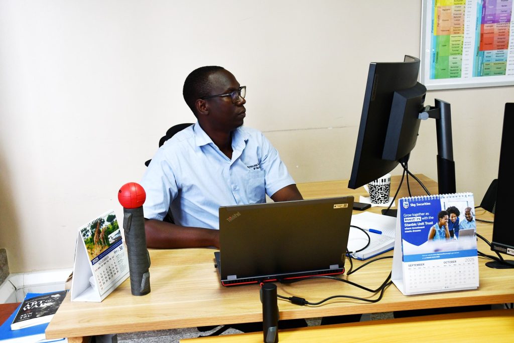 Mr. Derrick Katusiime, Sedrik's supervisor at his workstation. Impact Stories: Sedrick Nuwagaba, a 35-year-old petroleum engineer and Mastercard Foundation Scholars Program alumnus actively contributing his expertise to the Petroleum Authority of Uganda, November 2025, Makerere University, Kampala Uganda, East Africa.