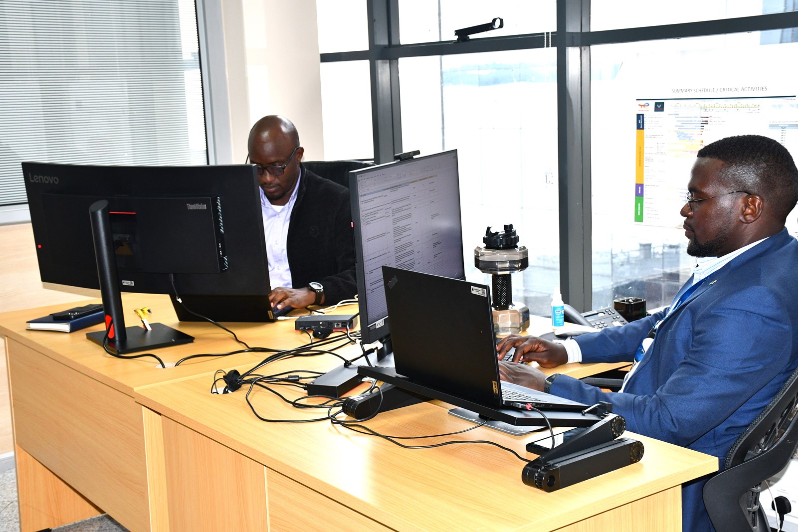 Sedrik with a colleague during their typical working hours at the Petroleum Authority of Uganda. Impact Stories: Sedrick Nuwagaba, a 35-year-old petroleum engineer and Mastercard Foundation Scholars Program alumnus actively contributing his expertise to the Petroleum Authority of Uganda, November 2025, Makerere University, Kampala Uganda, East Africa.