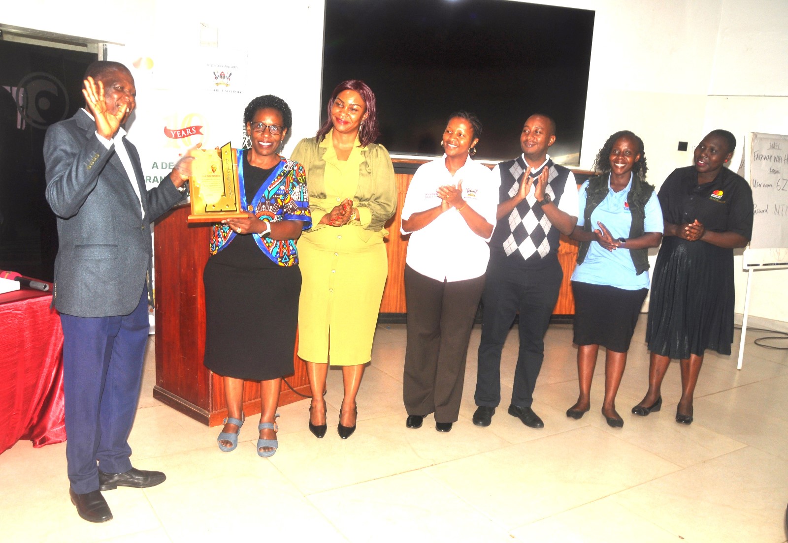Prof. Justine Namaalwa, the Program Director together with some of the staff, handing over a plaque to Prof. Peter Turyakira in recognition of his longstanding mentorship to Scholars. Mastercard Foundation Scholars Program at Makerere University annual workshop for mentors, 13th November 2025, Fairway Hotel, Kampala Uganda, East Africa.