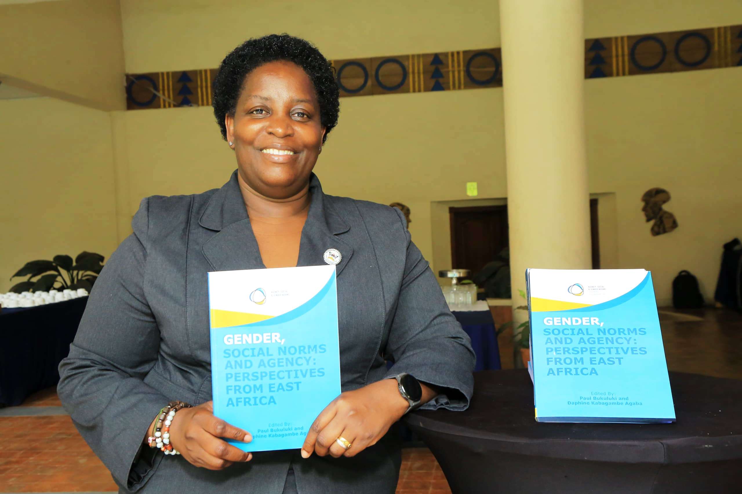 Prof. Helen Nambalirwa Nkabala poses with a copy of the book. Makerere University Press launch of highly anticipated book “Gender, Social Norms and Agency: Perspectives from East Africa”, Edited by Professor Paul Bukuluki and Dr. Daphine Agaba Kabagambe. November 2025, Golf Course Hotel, Kampala Uganda, East Africa.