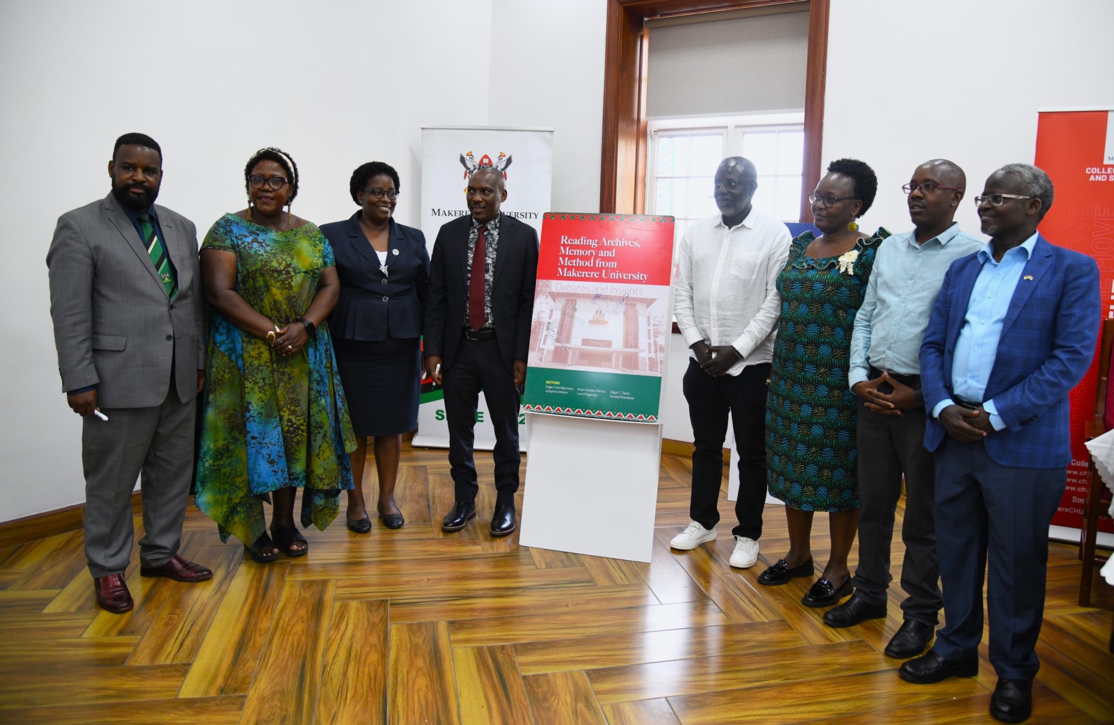 A group photo with the "Reading Archives, Memory and Method from Makerere University" book dummy. College of Humanities and Social Sciences (CHUSS) on 11th December 2025 celebrated the launch of five scholarly books, marking a significant milestone in the College’s contribution to academic research and discourse, Senior Common Room, Main Building, Makerere University, Kampala Uganda, East Africa.