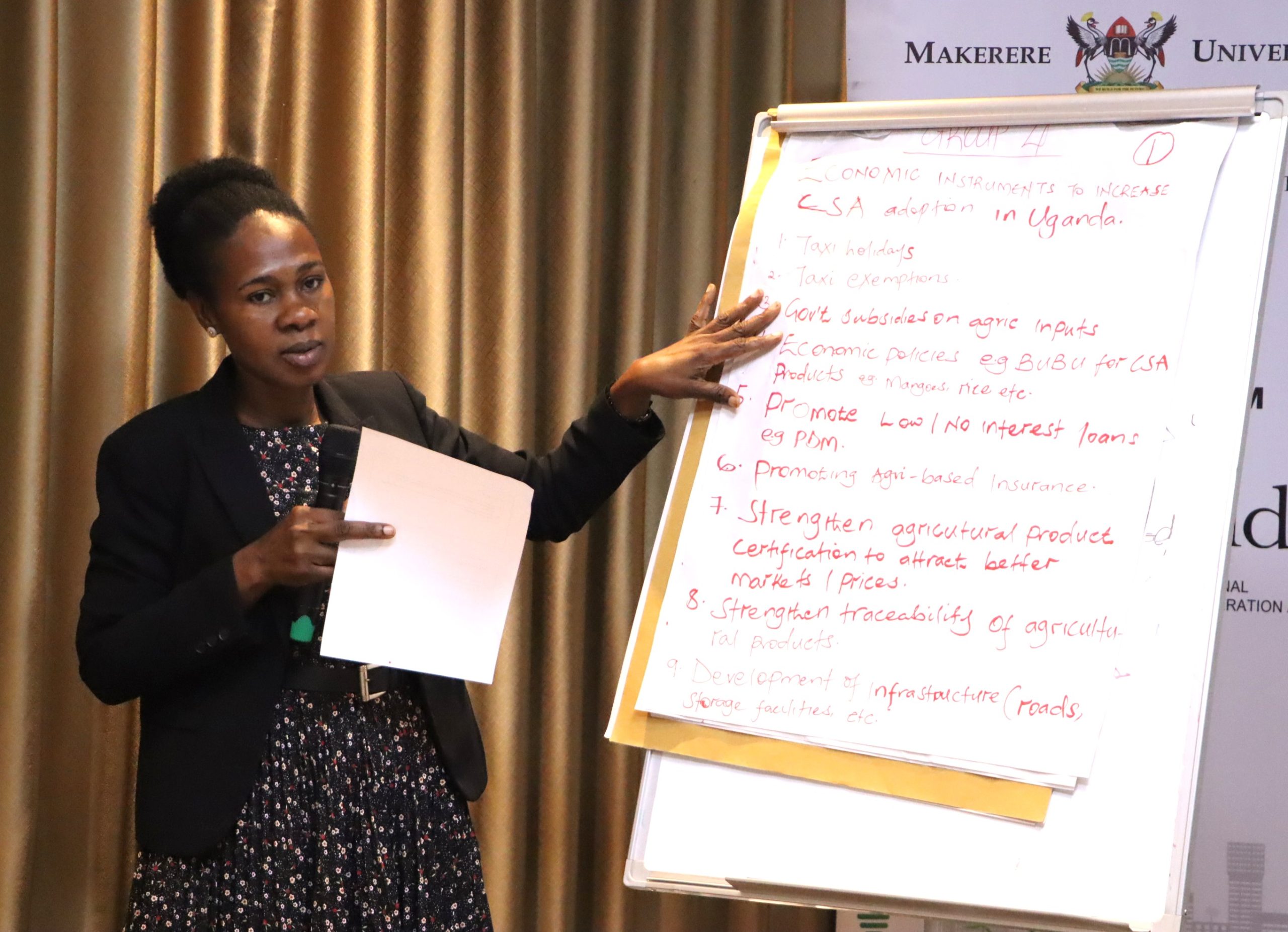 Catherine Kirabo from the Ministry of Water and Environment presenting the results from her group discussion. The high-level annual workshop organised by the Environment for Development (EfD) Makerere University Centre through its regional Inclusive Green Economy (IGE) Programme to draw a roadmap for accelerating the adoption of Climate Smart Agriculture (CSA) as Uganda struggles with rising climate shocks, stagnating agricultural productivity and worsening poverty levels, held on December 4, 2025 at the Sheraton Kampala Hotel, Uganda, East Africa.
