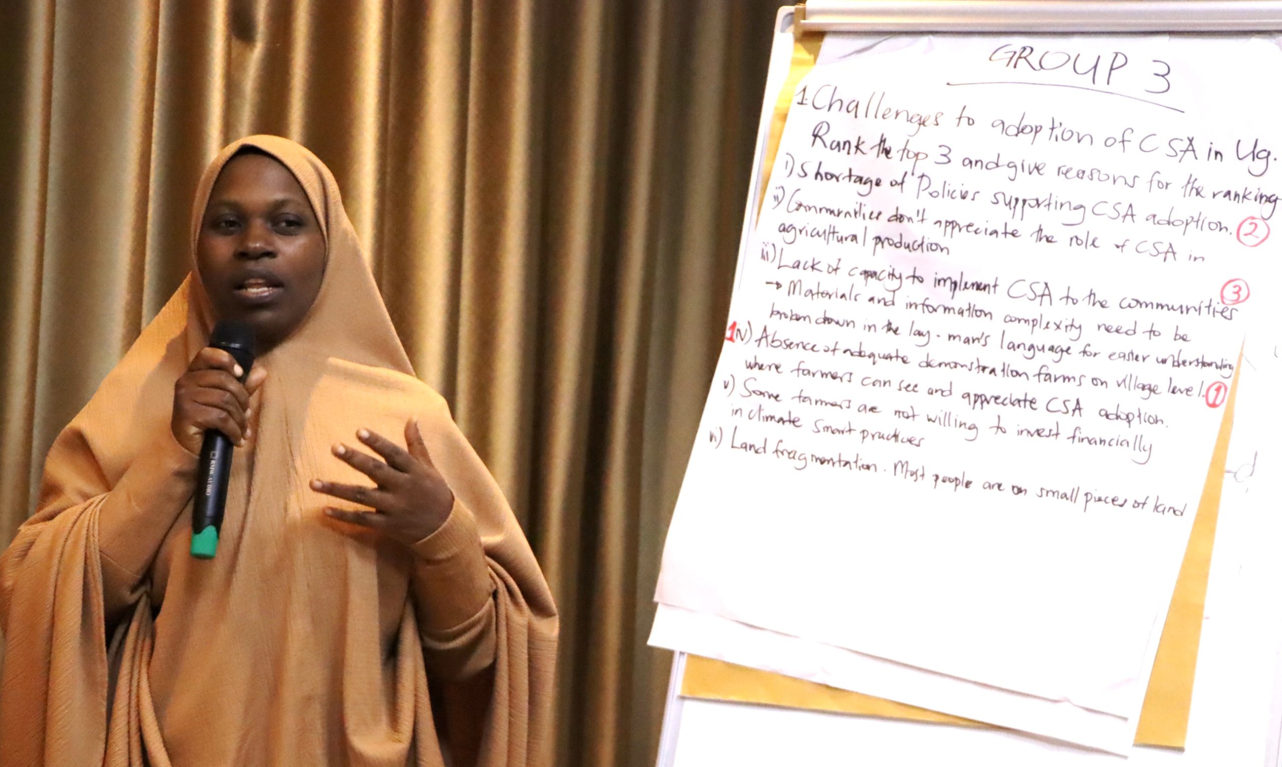 Dr. Aisha from EfD Mak center presenting the output from her group discussion. The high-level annual workshop organised by the Environment for Development (EfD) Makerere University Centre through its regional Inclusive Green Economy (IGE) Programme to draw a roadmap for accelerating the adoption of Climate Smart Agriculture (CSA) as Uganda struggles with rising climate shocks, stagnating agricultural productivity and worsening poverty levels, held on December 4, 2025 at the Sheraton Kampala Hotel, Uganda, East Africa.