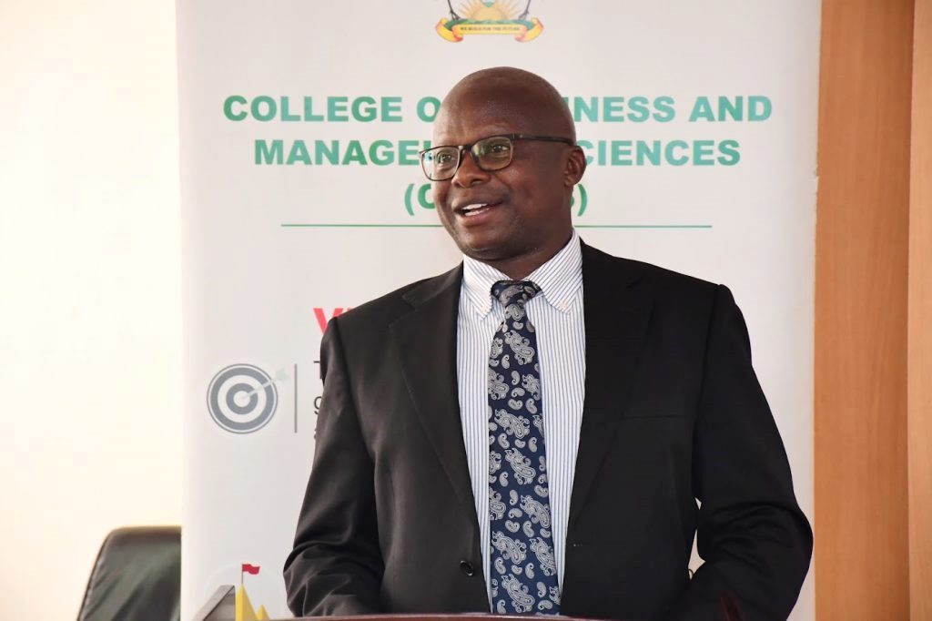 The Deputy Principal of CoBAMS, Associate Professor James Wokadala, giving his remarks about the working paper series by tracing the Origins and its impact on Research. College of Business and Management Sciences (CoBAMS) Working Paper Series 2025 launch by Prof. Sarah Ssali. It consists of over 60 working papers with research set to transform society, inform policy formulation, decision making, governance, development. 4th December 2025, CoBAMS Conference Room, Block B, School of Business, Makerere University, Kampala Uganda, East Africa.