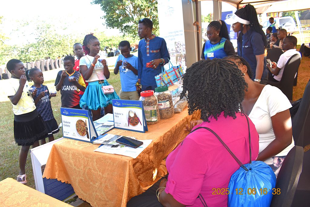 Children visit the NutriFishPlus Project stall. Makerere University, through the College of Natural Sciences (CoNAS), recognized for its outstanding contribution to the development of the fisheries sector in Uganda, award was presented during the Sustainable Fisheries, Aquaculture, and Environmental Awards Ceremony at the 7th edition of the Jinja Fish Festival, 6th–7th December 2025, Across the Nile Resort, along the banks of the River Nile, Njeru Municipality, Buikwe District, Uganda, East Africa.