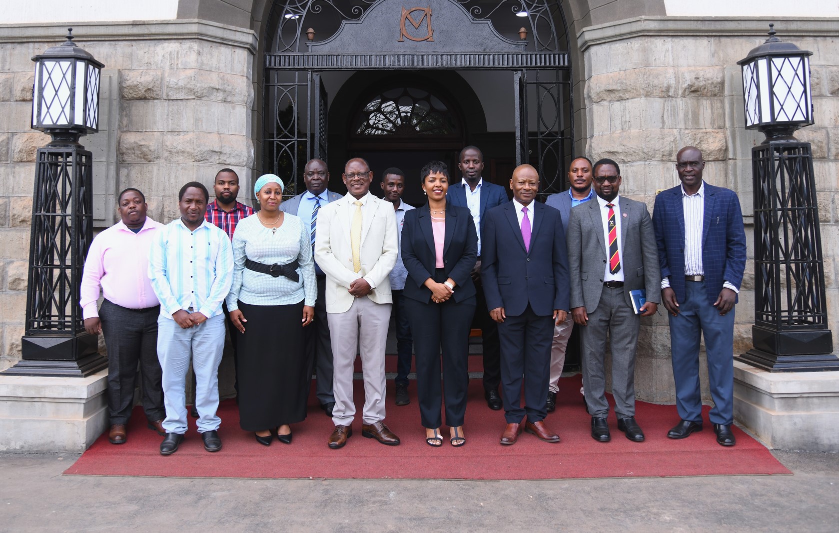 Prof. Barnabas Nawangwe (4th Left) and Dr. Allen Kabagenyi (4th Right) pose for a group photo with Mak-HUC Members and officials at the Main Building Entrance. Makerere University Health User Committee (Mak-HUC)—established by the Vice Chancellor in 2022 as part of his strategic mandate to strengthen and oversee the University’s health service delivery-official handover of status report, 11th December 2025, Main Building, Kampala Uganda, East Africa.