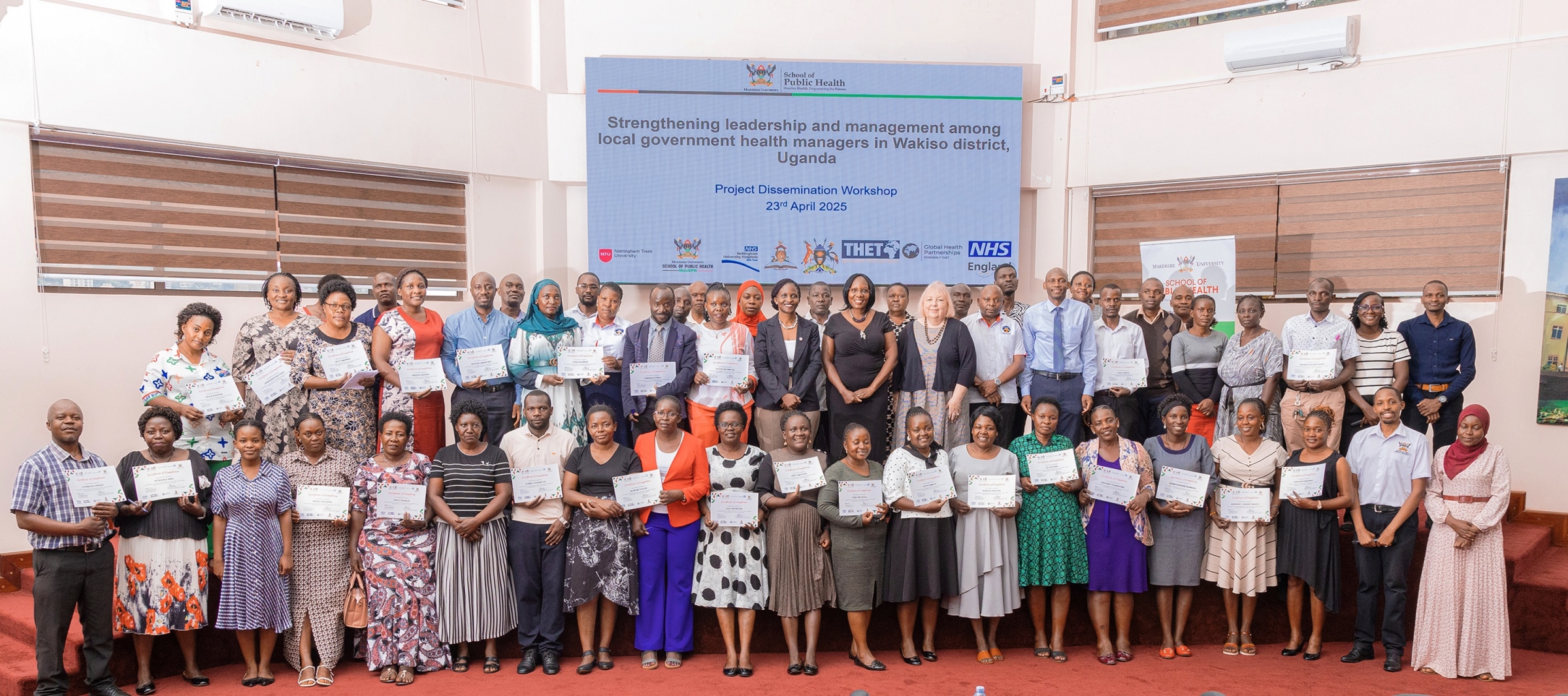 Participants pose for a group photo at the "Strengthening leadership and management among local government health managers in Wakiso district, Uganda", Project Dissemination Workshop held on 23rd April 2025 in the MakSPH Auditorium, Makerere University School of Public Health (MakSPH) Kampala Uganda, East Africa.