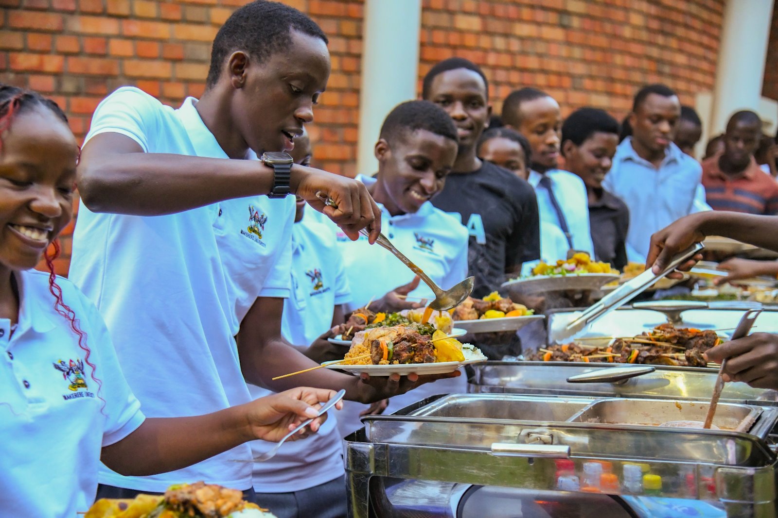 Safeguarding Champions serve dinner. Makerere University student and staff Safeguarding Champions celebration of Semester One achievements, 28th November 2025, Makerere Institute of Social Research (MISR) Gardens, Kampala Uganda, East Africa.