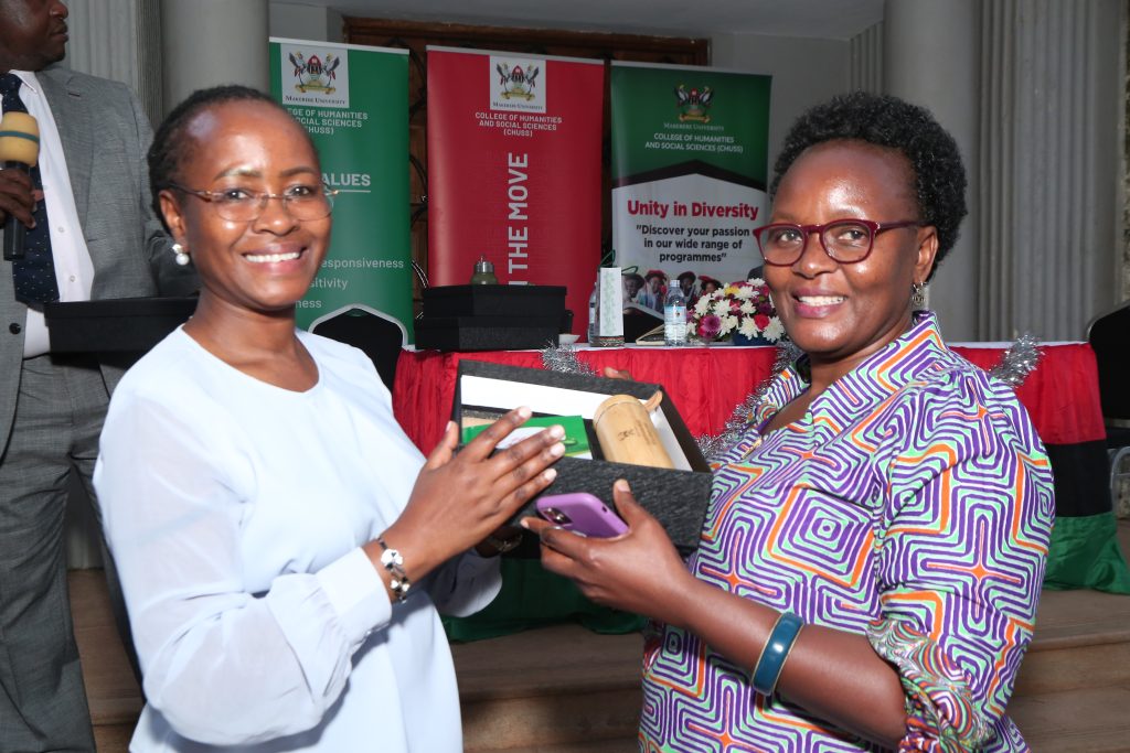DVC (AA) Prof. Sarah Ssali hands over the award to Dr. Pamela Khanakwa during CHUSS End of year party on 12th December 2025. Dr. Pamela Khanakwa Honored for Steering Record 18 PhD Candidates for the Mak 2026 Graduation, School of Liberal and Performing Arts, College of Humanities and Social Sciences (CHUSS), Makerere University, Kampala Uganda, East Africa.