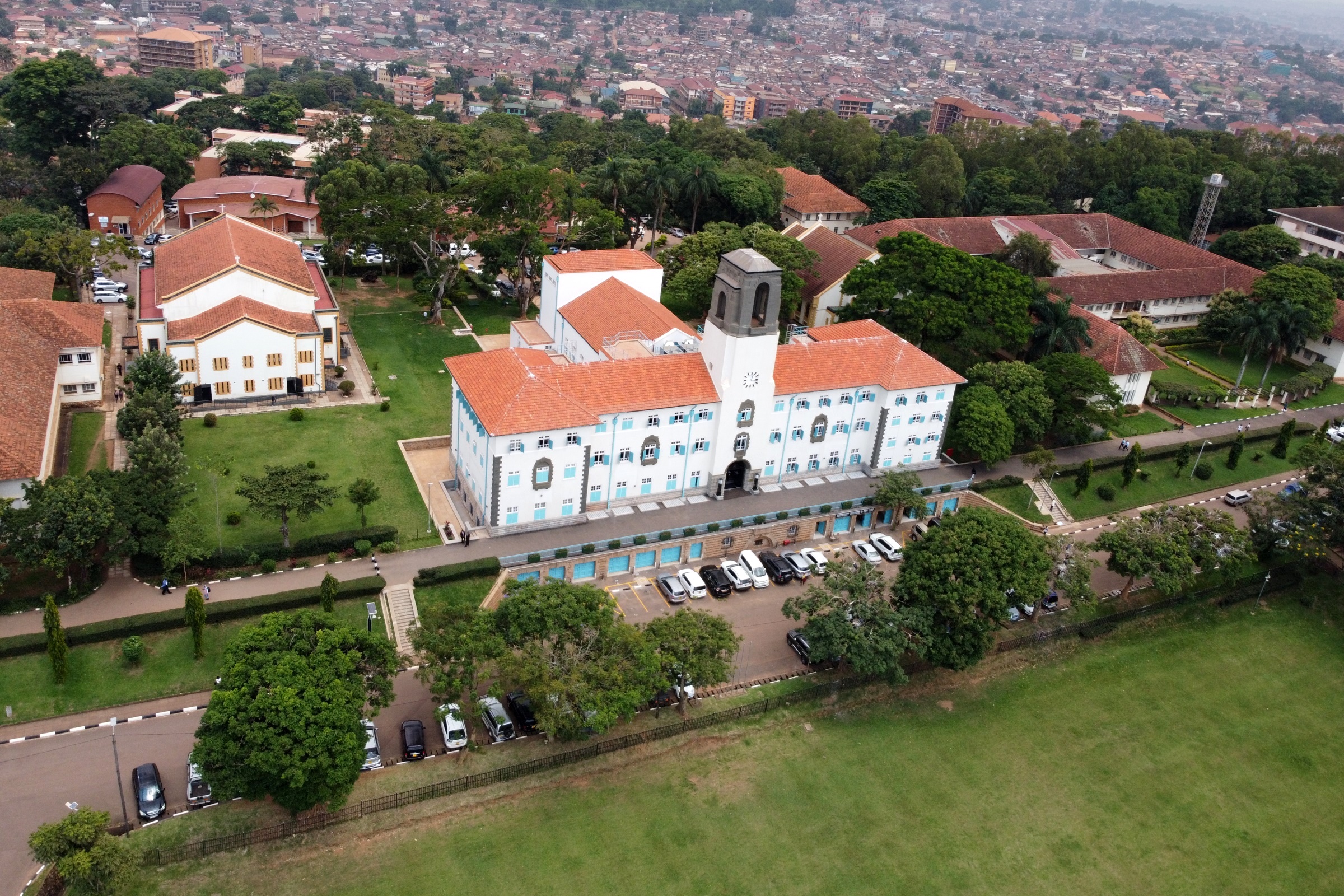 An aerial shot of the Main Building, as taken by a drone over the Freedom Square with Left to Right: CHUSS, St. Francis, St. Augustine and CAES Buildings and the Kikoni area (Background) in view. Makerere University, Kampala Uganda, East Africa.
