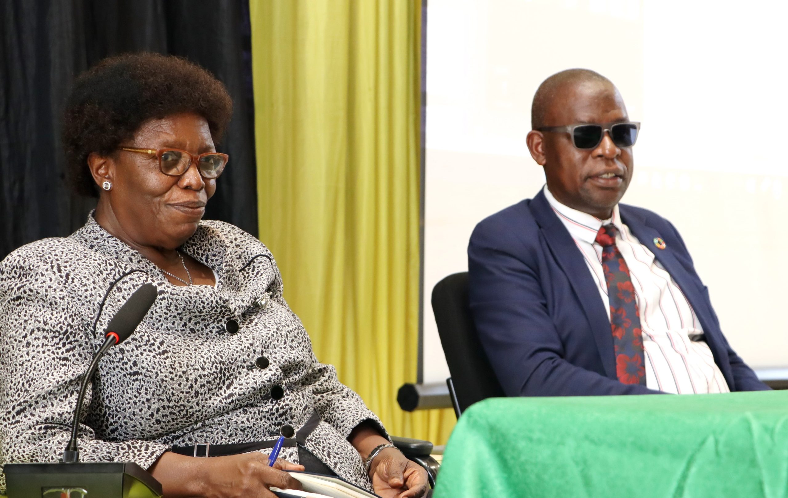 Prof. Mary Okwakol (Left) and Dr. Vincent Ssembatya listen to feedback from leaders. National Council for Higher Education (NCHE) validation meeting of the draft minimum standards for implementing Competence-Based Education (CBE) in Higher Education Institutions, Yusuf Lule Central Teaching Facility Auditorium, 23rd January 2026, Makerere University, Kampala Uganda, East Africa.