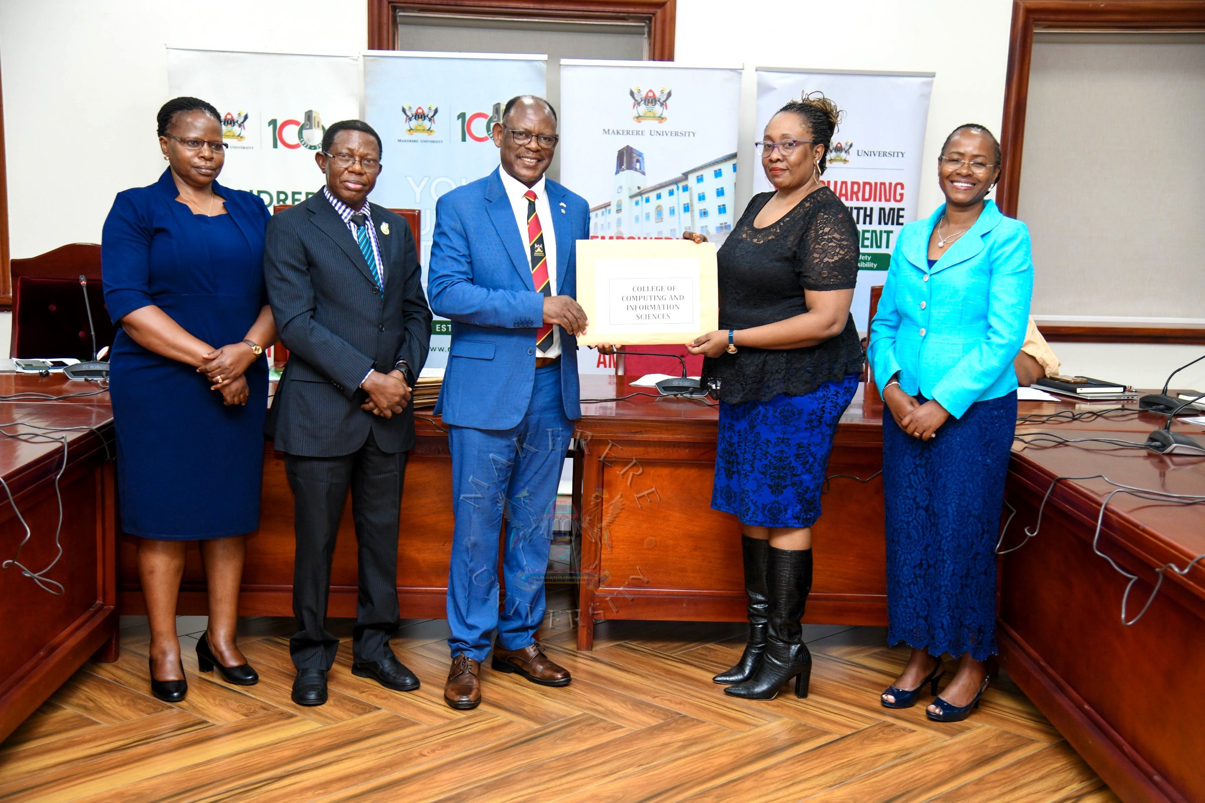 Prof. Barnabas Nawangwe (Centre) presents one of the printed batches of transcripts the Registrar College of Computing and Information Sciences (CoCIS)-Ms. Ruth Iteu Eyoku (2nd Right) as Right to Left: DVCAA-Prof. Sarah Ssali, AR-Prof. Buyinza Mukadasi and Ms. Prossy Nakayiki witness on 28th January 2026. Vice Chancellor's Press Briefing on the 76th Graduation due to be held 24th-27th February 2026 at Makerere University, Kampala Uganda, East Africa.