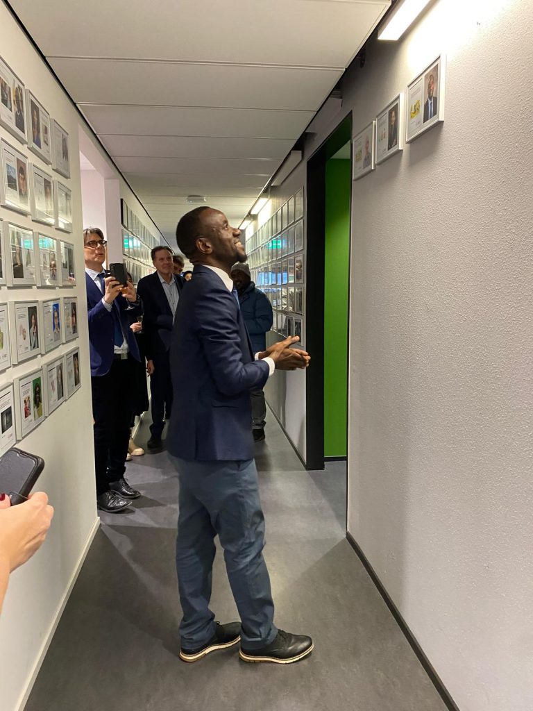 Kabwama admires his portrait on the Wall of Fame, which showcases a collection of portraits of doctoral students, a practice held since the 1950s.
