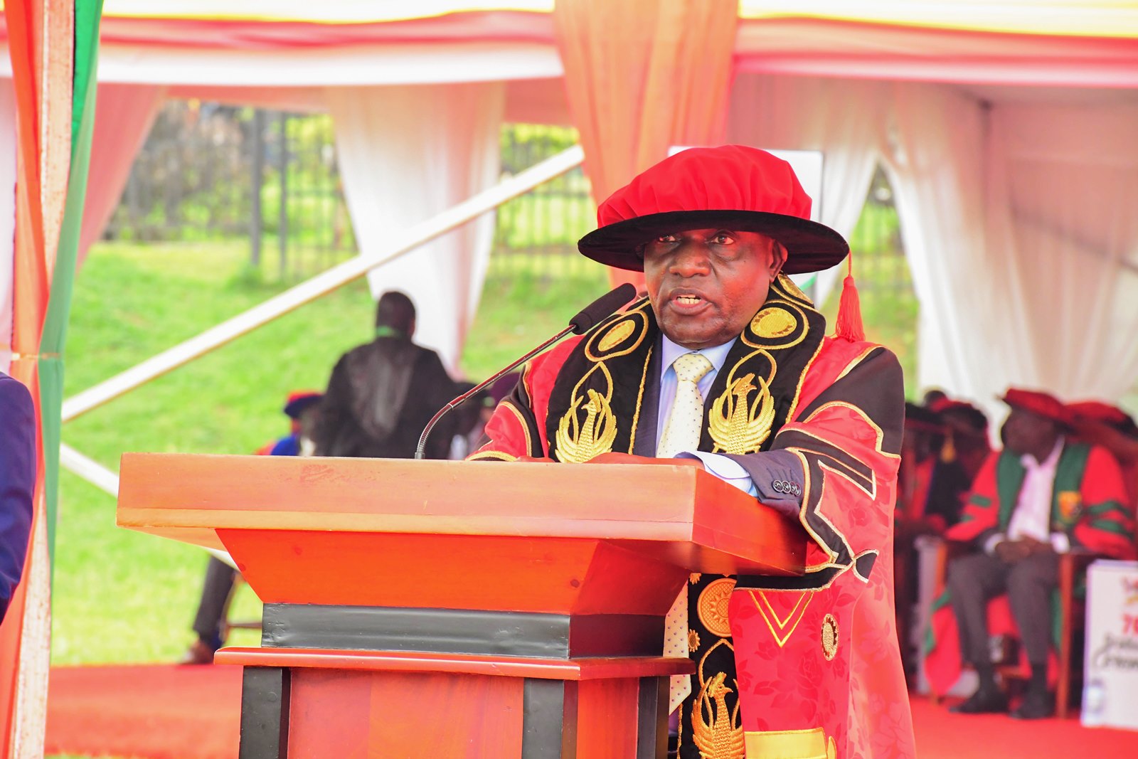 The Chancellor Makerere university, Hon. Dr. Crispus Kiyonga presenting his remarks at the 76th congregation. 76th Graduation Ceremony, Day 3, College of Business and Management Sciences (CoBAMS). Commencement Speaker-Dr. Patricia Adongo Ojangole, Managing Director, Uganda Development Bank Limited. 26th February 2026, Freedom Square, Makerere University, Kampala Uganda, East Africa.