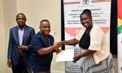 Ms. Monica Edemachu Ejua (Right) presents a certificate to one of the MoKCC&MA Officials as Prof. Eria Hisali (Left) witnesses. Four-day training for Ministry of Kampala Capital City and Metropolitan Affairs (MoKCC&MA) officials on Integrating and Managing Environmental, Social, Health and Safety (ESHS) Safeguards in Procurement conducted by the Public Investment Management (PIM) Centre of Excellence certificate award ceremony, 13th February 2026, College of Business and Management Sciences, Makerere University, Kampala Uganda, East Africa.