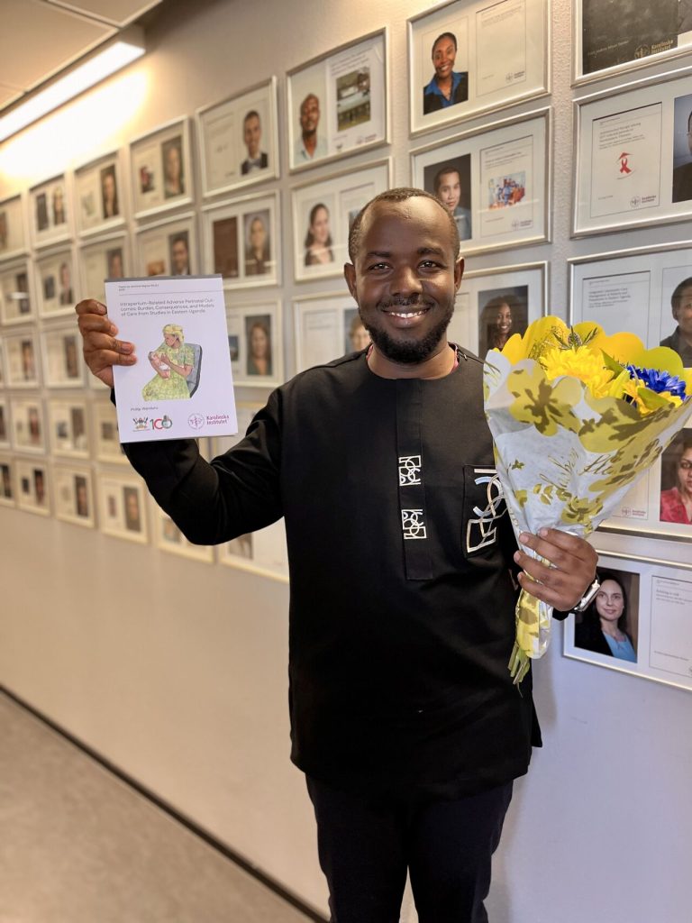 Phillip Wanduru holds a bound copy of his Thesis shortly after his Defense at the David Widerström Building in Solna, Sweden. Makerere University School of Public Health Communications Office, Graduation Profiles Series, 76th Graduation Ceremony, Phillip Wanduru, “Intrapartum-Related Adverse Perinatal Outcomes: Burden, Consequences, and Models of Care from Studies in Eastern Uganda,” Kampala Uganda, East Africa.