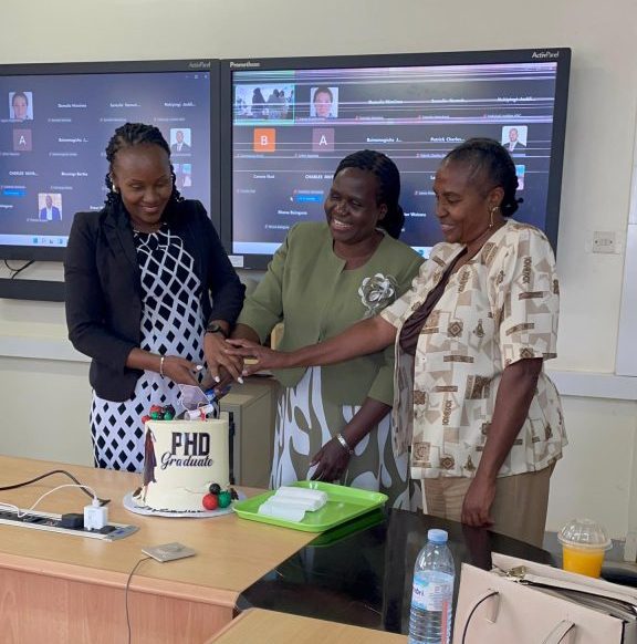Dr. Namukose (c) flanked by her supervisors, Associate Professor Suzanne Kiwanuka (L) and Dr. Wamuyu Gakenia Maina, in a cake-cutting ceremony shortly after her PhD defense on October 15, 2025.