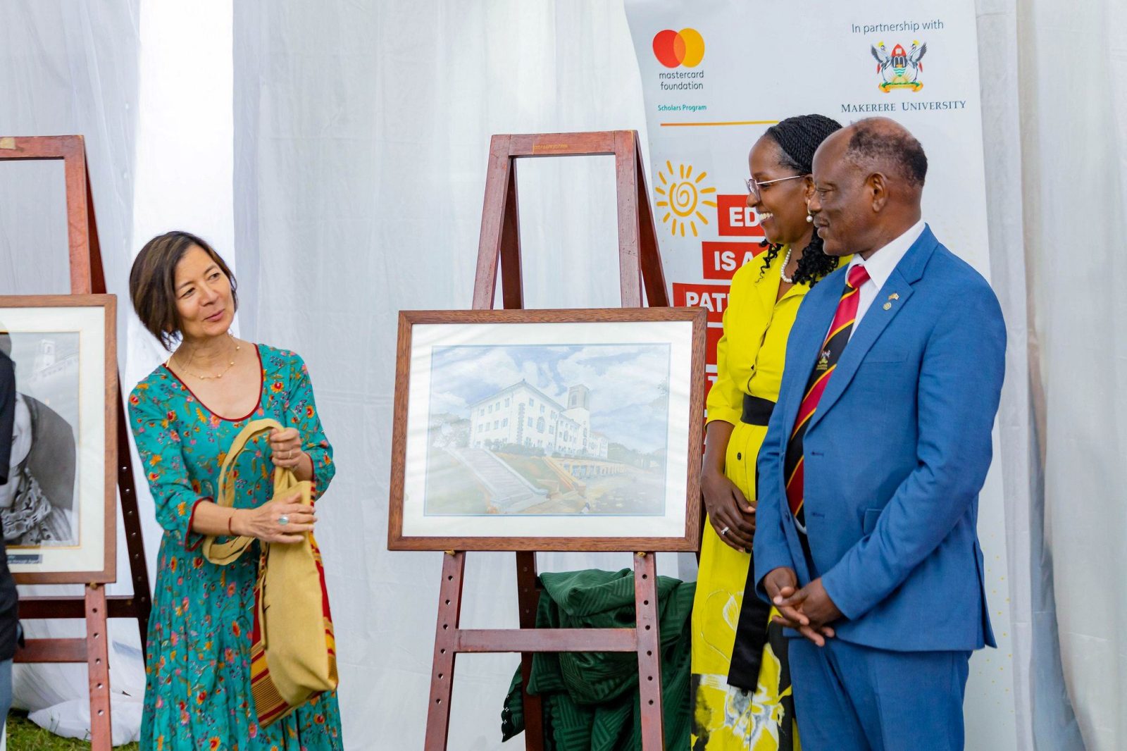 Ms. Reeta Roy, receiving some memorabilia from Dr. Lorna Magara and Prof. Barnabas Nawangwe during the event. Celebrating 13 years of a significant partnership with the Mastercard Foundation and honorary Doctor of Laws conferred upon Ms. Reeta Roy, the Founding President and CEO of the Mastercard Foundation, 27th February 2026, Makerere University, Kampala Uganda, East Africa.