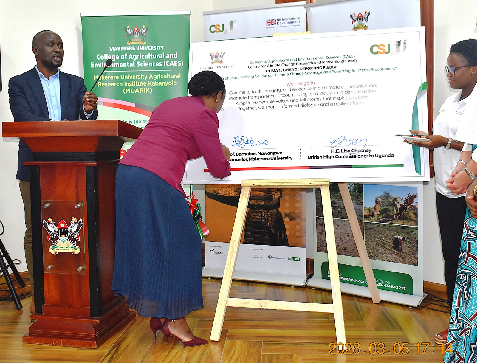 Prof. Sarah Ssali appends her signature on the plaque after the launch of the climate change training course for media practitioners. Launch of specialized short training course developed by Makerere University Centre for Climate Change Research and Innovation (MUCCRI) aimed at equipping media practitioners and digital content creators with knowledge and skills to effectively report on climate change and related environmental issues by British High Commissioner to Uganda, H.E. Lisa Chesney, 5th March 2026, Senior Common Room, Main Building, Kampala Uganda, East Africa.