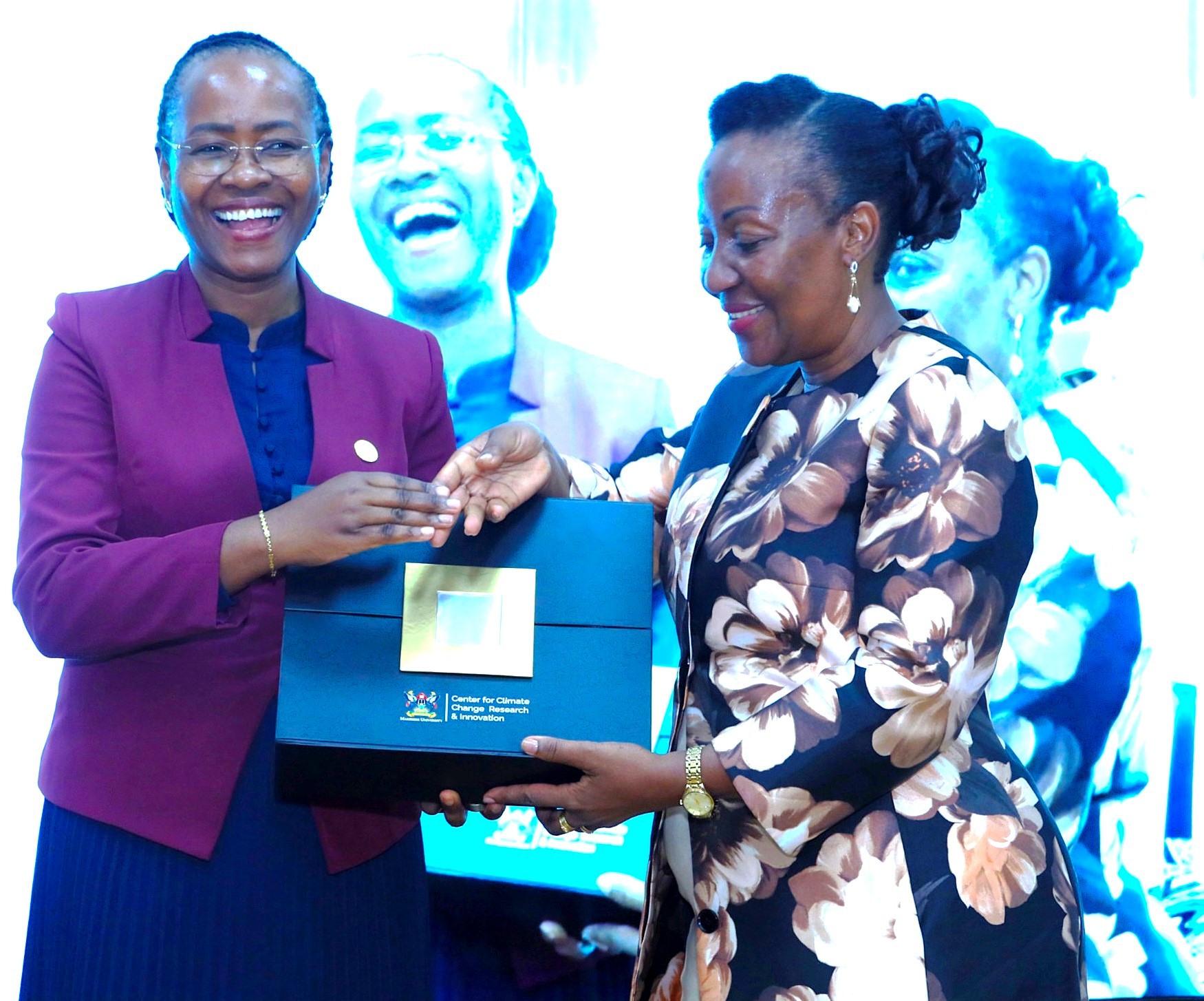 Prof. Gorettie Nabanoga presenting a gift from MUCCRI from Prof. Sarah Ssali. Launch of specialized short training course developed by Makerere University Centre for Climate Change Research and Innovation (MUCCRI) aimed at equipping media practitioners and digital content creators with knowledge and skills to effectively report on climate change and related environmental issues by British High Commissioner to Uganda, H.E. Lisa Chesney, 5th March 2026, Senior Common Room, Main Building, Kampala Uganda, East Africa.