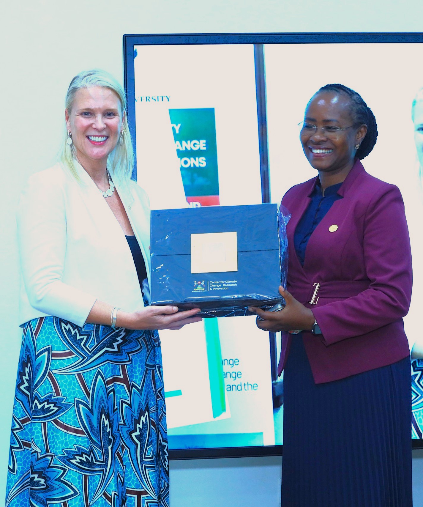 Prof. Sarah Ssali presenting a gift from MUCCRI to H.E. Lisa Chesney. Launch of specialized short training course developed by Makerere University Centre for Climate Change Research and Innovation (MUCCRI) aimed at equipping media practitioners and digital content creators with knowledge and skills to effectively report on climate change and related environmental issues by British High Commissioner to Uganda, H.E. Lisa Chesney, 5th March 2026, Senior Common Room, Main Building, Kampala Uganda, East Africa.