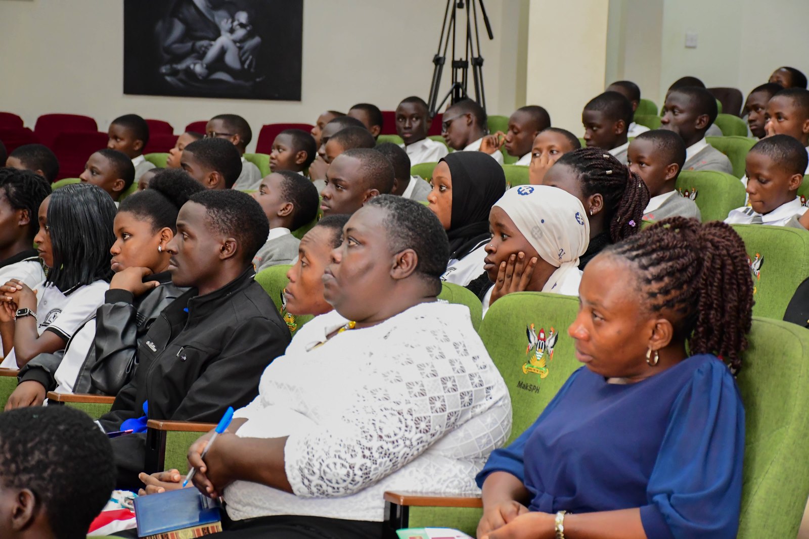 Some of the participants following the proceedings of the Stakeholders' Exhibition. School Stakeholders’ Exhibition, bringing together learners, teachers, researchers, and education policymakers to demonstrate how Uganda’s Competence Based Curriculum (CBC) can be implemented through experiential learning and real-life situations, by graduate students of College of Education and External Studies (CEES) and College of Humanities and Social Sciences (CHUSS) guided by Dr. Anne Ampaire, 26th March 2026, Makerere University School of Public Health Auditorium, Kampala Uganda, East Africa.