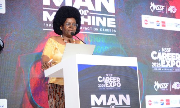 Hon. Dr. Monica Musenero delivering a keynote address on day one of the career fair. Three-day Careers Fair 2026, bringing together students, industry leaders, and policymakers to discuss the future of work in the era of Artificial Intelligence (AI), Day 1 held under the theme “Machine vs. Man” and sponsored by the National Social Security Fund (NSSF), 11th March 2026, Yusuf Lule Central Teaching Facility Auditorium, Makerere University, Kampala Uganda, East Africa.
