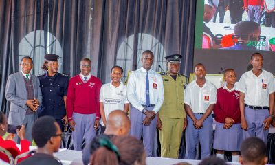 Prof. Buyinza Mukadasi (L) with CP Anatoli Muleterwa (4th R) and Alaso Immaculate Emily (2nd L) pose for a group photo with some of the secondary school students that attended Day 3 of the Careers Fair on 13th March 2026. Three-day Careers Fair 2026, bringing together students, industry leaders, and policymakers to discuss the future of work in the era of Artificial Intelligence (AI), Day 3, Grand Finale, held under the theme “Connecting Potential to Purpose: Partnerships for Sustainable Impact”, 13th March 2026, Freedom Square, Makerere University, Kampala Uganda, East Africa.