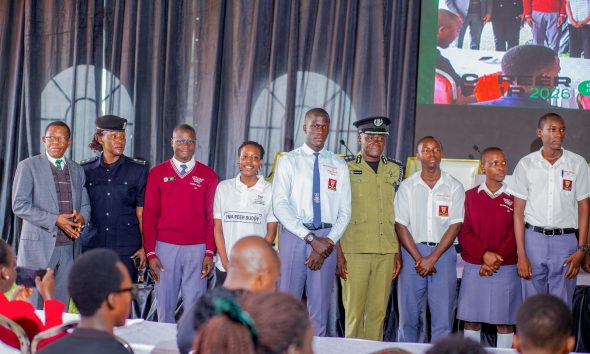 Prof. Buyinza Mukadasi (L) with CP Anatoli Muleterwa (4th R) and Alaso Immaculate Emily (2nd L) pose for a group photo with some of the secondary school students that attended Day 3 of the Careers Fair on 13th March 2026. Three-day Careers Fair 2026, bringing together students, industry leaders, and policymakers to discuss the future of work in the era of Artificial Intelligence (AI), Day 3, Grand Finale, held under the theme “Connecting Potential to Purpose: Partnerships for Sustainable Impact”, 13th March 2026, Freedom Square, Makerere University, Kampala Uganda, East Africa.