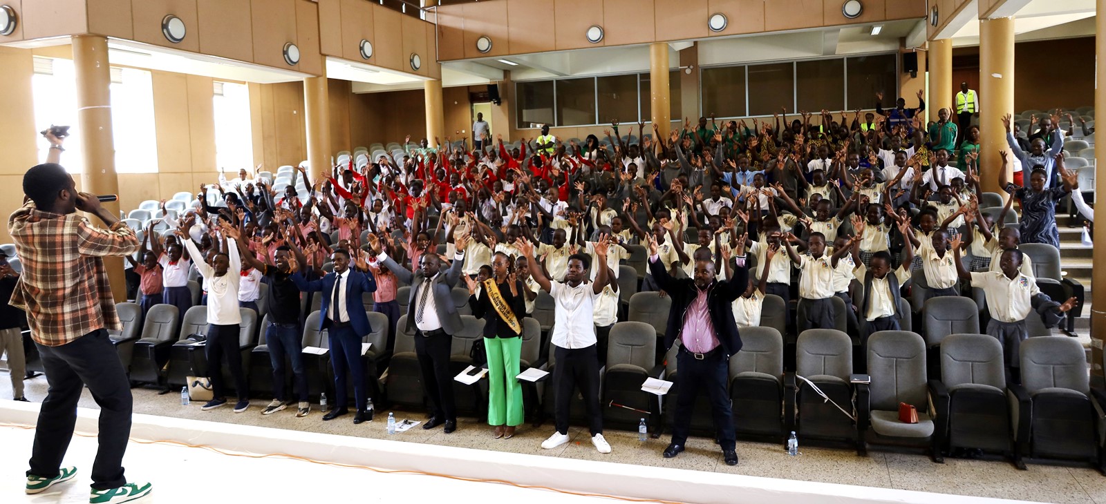 A section of Primary and secondary school childten praising God with Bruno K DJ during the break session. Inaugural Schools Environmental Conference organised by the Environment for Development (EfD) Uganda in partnership with the Green Vests Initiative, the National Environment Management Authority (NEMA), and the Kampala Capital City Authority (KCCA), theme “Strengthening Environmental Stewardship in Schools”, 20th March 2026, Yusuf Lule Central Teaching Facility Auditorium, Makerere University, Kampala Uganda, East Africa.