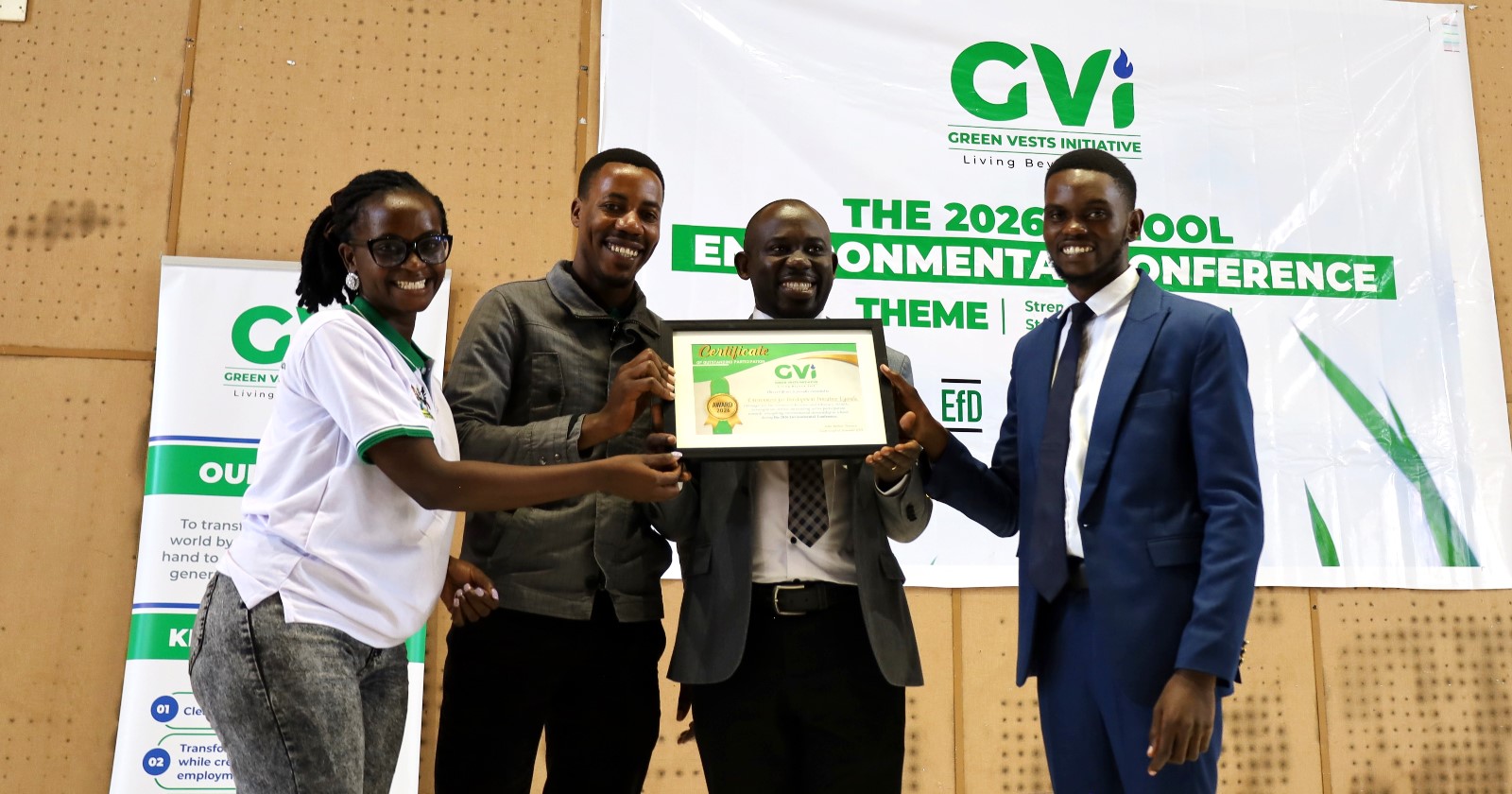 Dr. Peter Babyenda (3rd) flanked by EfD Members receives certificate after presentation. Inaugural Schools Environmental Conference organised by the Environment for Development (EfD) Uganda in partnership with the Green Vests Initiative, the National Environment Management Authority (NEMA), and the Kampala Capital City Authority (KCCA), theme “Strengthening Environmental Stewardship in Schools”, 20th March 2026, Yusuf Lule Central Teaching Facility Auditorium, Makerere University, Kampala Uganda, East Africa.