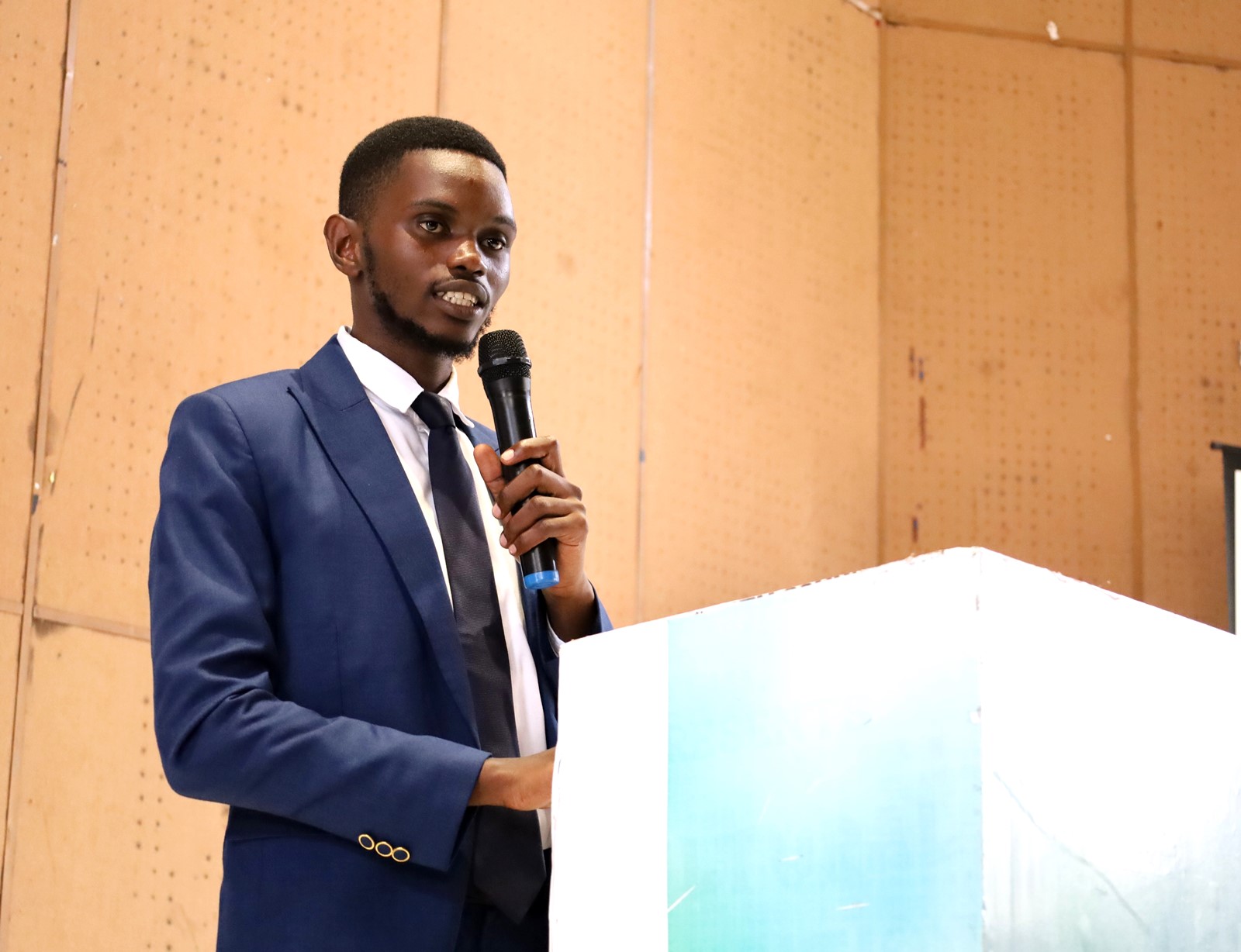 John Roberts Tenywa Team lead GVi speaking on the initiative objectives. Inaugural Schools Environmental Conference organised by the Environment for Development (EfD) Uganda in partnership with the Green Vests Initiative, the National Environment Management Authority (NEMA), and the Kampala Capital City Authority (KCCA), theme “Strengthening Environmental Stewardship in Schools”, 20th March 2026, Yusuf Lule Central Teaching Facility Auditorium, Makerere University, Kampala Uganda, East Africa.