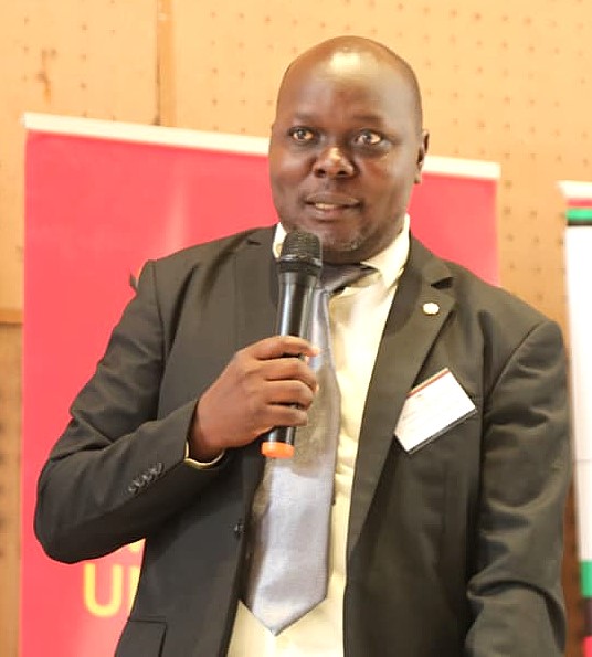 Dr. Jimmy Okello from UNEB responding to concerns regarding the gaps in curriculum development and assessment processes during the dissemination workshop. Dissemination of findings of Nationwide study by the School of Biosciences, College of Natural Sciences (CONAS), undertaken among 5,000 participants across 100 districts in response to growing concerns over the long-term decline in Biology performance in the Uganda Advanced Certificate of Education (UACE) examinations, 19th March 2026, Yusuf Lule Central Teaching Facility Auditorium, Makerere University, Kampala Uganda, East Africa.