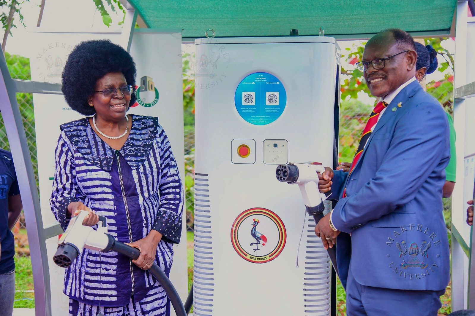 Hon. Dr. Monica Musenero (L) and Prof. Barnabas Nawangwe (R) hold the Electric Fast-Charging Station's cables after the launch on 13th March 2026. Hon. Dr. Monica Musenero commissions first DC Electric C6-180 Fast-Charging Station installed in collaboration with Kiira Motors Corporation (KMC), Senate Building Parking Lot, Makerere University, Kampala Uganda, East Africa on Friday 13th March 2026.