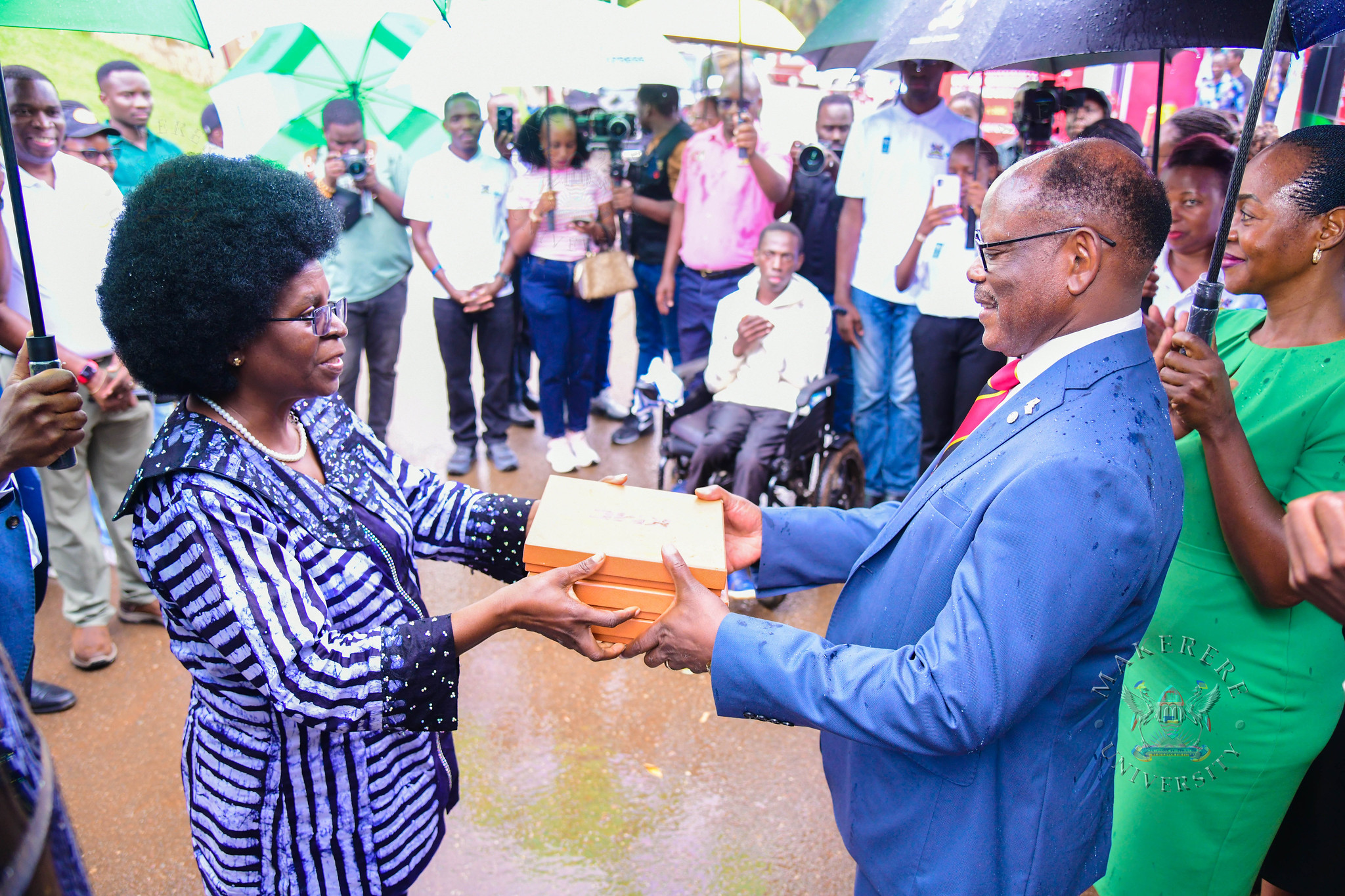 Hon. Dr. Musenero hands over the keys to the KMC buses to Prof. Barnabas Nawangwe. Hon. Dr. Monica Musenero commissions first DC Electric C6-180 Fast-Charging Station installed in collaboration with Kiira Motors Corporation (KMC), Senate Building Parking Lot, Makerere University, Kampala Uganda, East Africa on Friday 13th March 2026.