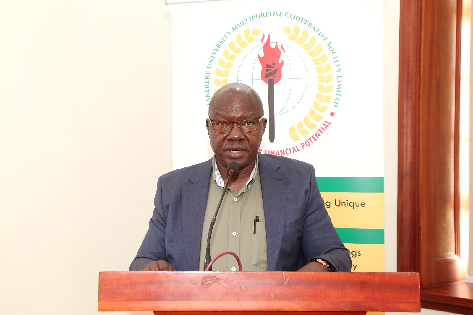 CPA David Ssenoga presenting the Auditor's Report. Makerere University Multi-Purpose Cooperative Society (MUMCS) Annual General Meeting (AGM), 4th March 2026, Senior Common Room, Main Building, Makerere University, Kampala Uganda, East Africa.