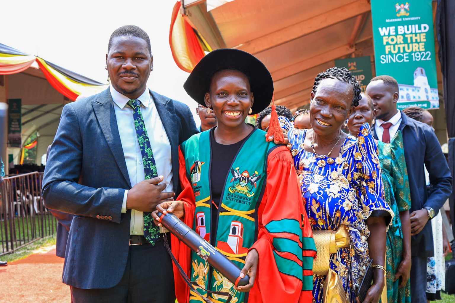Dr. Harriet Aber (centre) poses with family members during Makerere University’s 76th Graduation Ceremony on February 25, 2026. Makerere University School of Public Health Communications Office, Graduation Profiles Series, 76th Graduation Ceremony, Dr. Harriet Aber Odonga, “Substance Use among Children in Mbale, Uganda: Health System Landscape and Support Structures,” Kampala Uganda, East Africa."