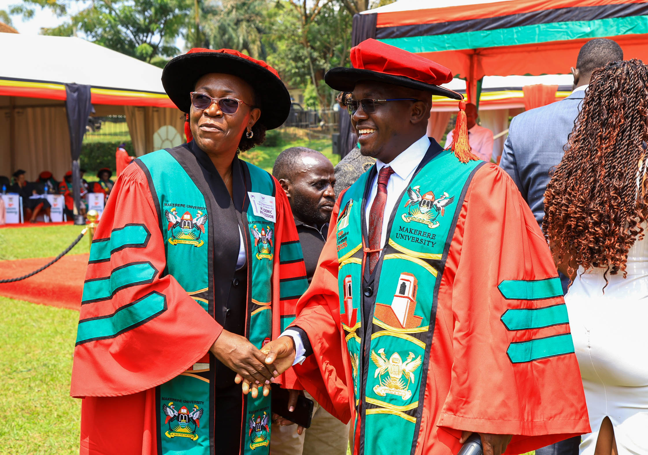 Assoc. Prof. Christine Nalwadda, Head of the Department of Community Health and Behavioural Sciences, congratulates Dr. Henry Komakech following his conferment of the Doctor of Philosophy in Public Health degree of Makerere University on February 25, 2026. Makerere University School of Public Health Communications Office, Graduation Profiles Series, 76th Graduation Ceremony, Dr. Henry Komakech, “Effects of the Repatriation of Refugees on the Health Services of the Host Populations in the West Nile Districts of Arua, Moyo, and Adjumani,” Kampala Uganda, East Africa.