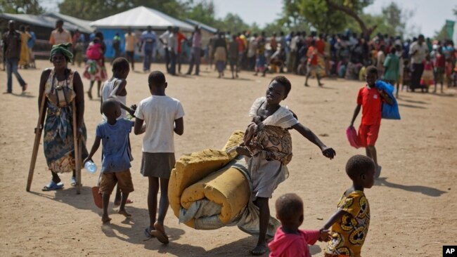 A young South Sudanese refugee carries a foam mattress toward a communal reception tent at Imvepi Reception Centre in northern Uganda on June 9, 2017, as newly arrived families undergo registration and settlement. Refugee influxes trigger rapid expansion of humanitarian support for shelter and essential services; as repatriation later occurs and partners withdraw, host systems often absorb these responsibilities with limited resources. Photo: Associated Press via VOA. Makerere University School of Public Health Communications Office, Graduation Profiles Series, 76th Graduation Ceremony, Dr. Henry Komakech, “Effects of the Repatriation of Refugees on the Health Services of the Host Populations in the West Nile Districts of Arua, Moyo, and Adjumani,” Kampala Uganda, East Africa.