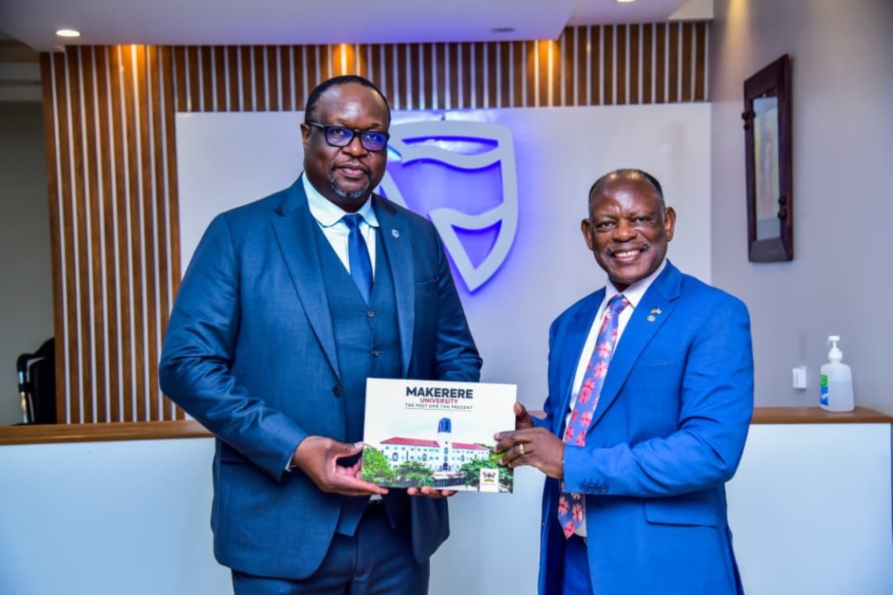 Prof. Barnabas Nawangwe gifting, Mr. Mumba Kalifungwa the University Centennial Coffee table booklet. Vice Chancellor, Makerere University, Prof. Barnabas Nawangwe courtesy visit to Stanbic Bank Uganda’s Chief Executive Officer, Mr Mumba Kalifungwa, 5th March 2026, Kampala Uganda, East Africa.