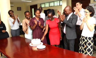 Ruth Asiimwe (in Red dress) cuts the cake in honor of her departure on 16th April 2026. Environment for Development (EfD) Centre bids farewell to third intern, Ruth Asiimwe, who secured a position with the African Development Bank in Juba South Sudan, 16th April 2026, Yusuf Lule Central Teaching Facility, Makerere University, Kampala Uganda, East Africa.