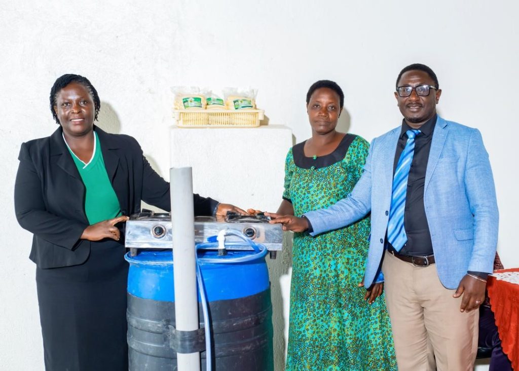 The Principal Investigator, Dr Patience Tugume and Resident City Commissioner, Mbarara City presenting a portable biogas system to Ms. Kibibi Monic. Department of Plant Sciences, Microbiology and Biotechnology, College of Natural Sciences (CoNAS), Makerere University, Kampala, project “Bio-innovation of biogas, biofertilizer, and biopesticide through the utilization of bio-waste” to promote transformation of household food waste into biogas and other valuable bio-products, dissemination of research findings to stakeholders in Mbarara City, 15th April 2026, Uganda, East Africa.