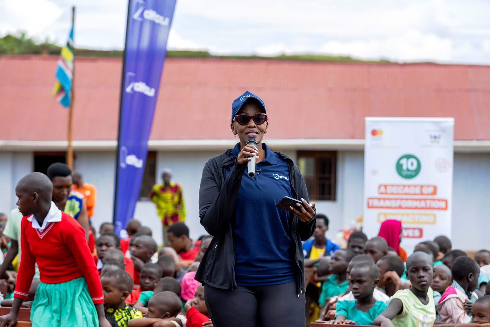 Ms Helena Mayanja. Mastercard Foundation Scholars Program at Makerere University Giveback, in partnership with dfcu Bank, handover five-classroom block equipped with 60 bench desks, four-stance modern pit latrine, and a 10,000-litre rainwater harvesting system on 1st April 2026 to Bwera Primary School in Kabale District, Uganda, East Africa.